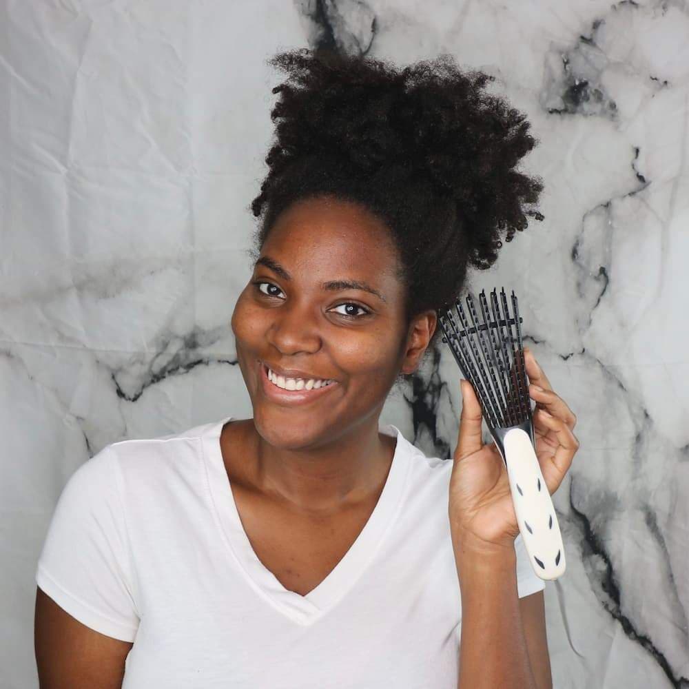The Wonderbrush, an easy detangler brush, resting on a pale surface