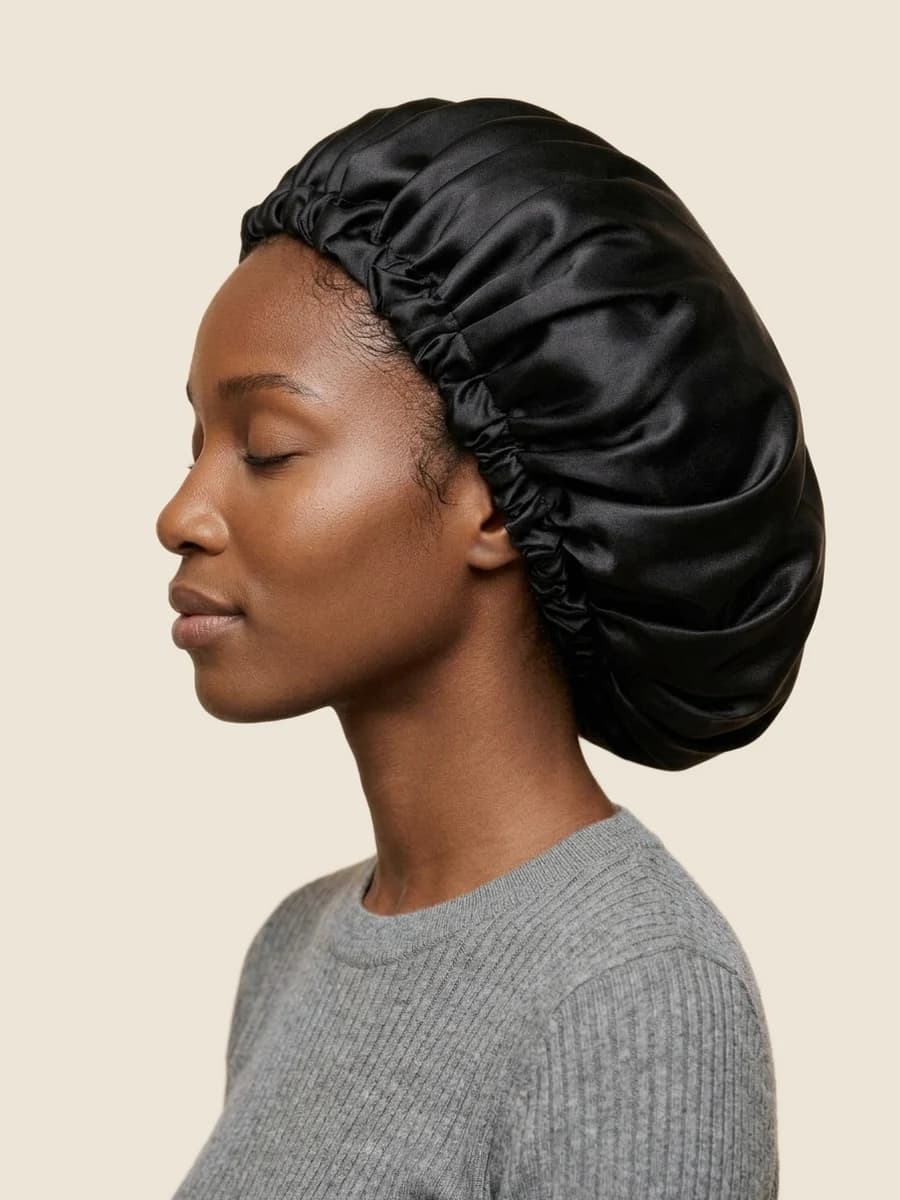 Woman in a black satin bonnet, side profile